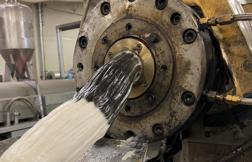 Purging compound clearing carbon contamination from a twin-screw extruder during changeover.